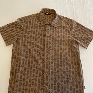 The North Face shortsleeved, button down shirt in a pine cone pattern.